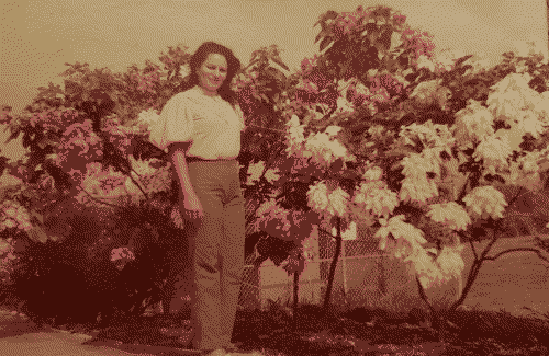 grandma in front of some flowers