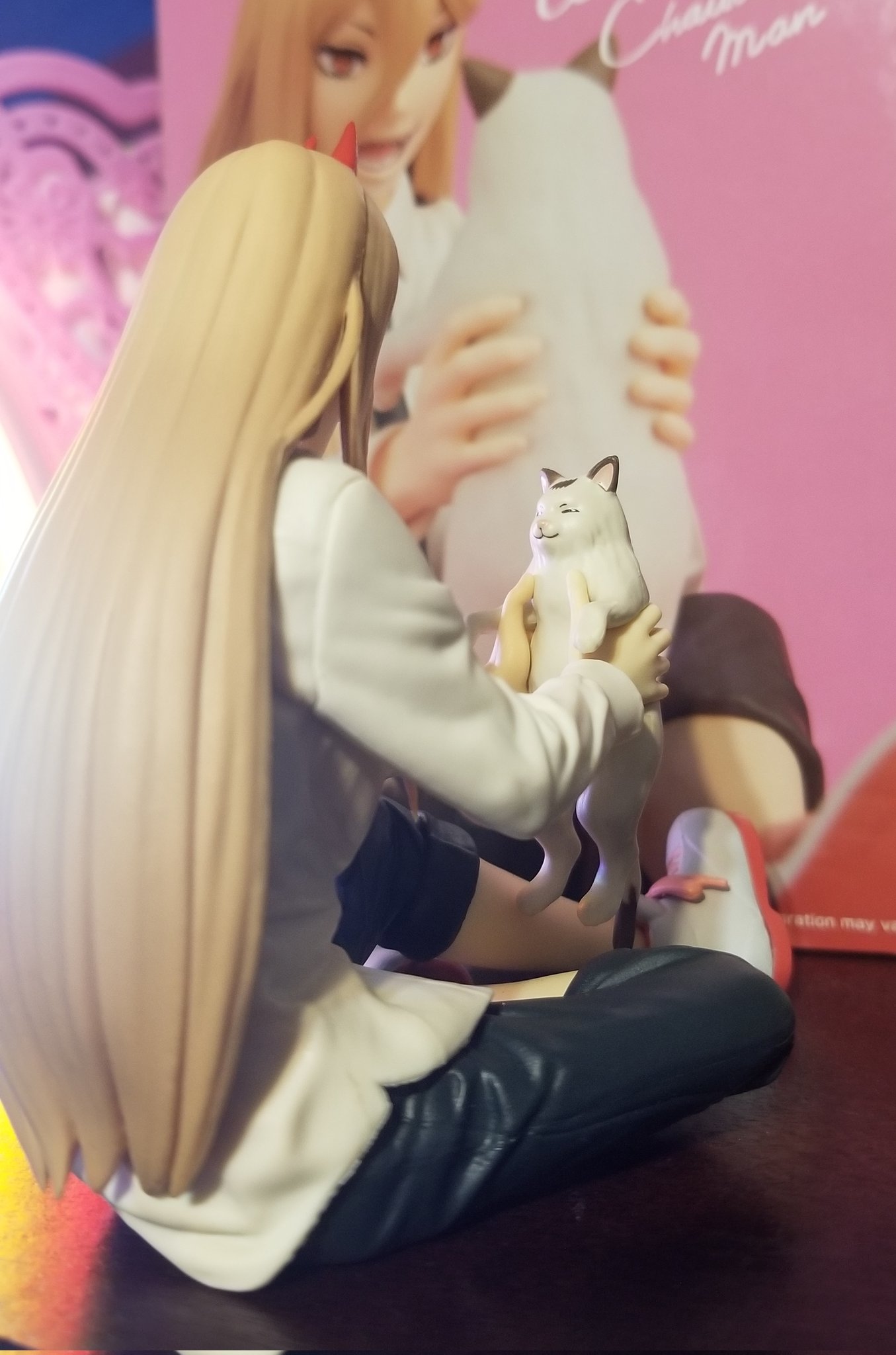 picture of an anime figurine. same figurine as the previous one but this picture is from another angle. you can see the cat's face.