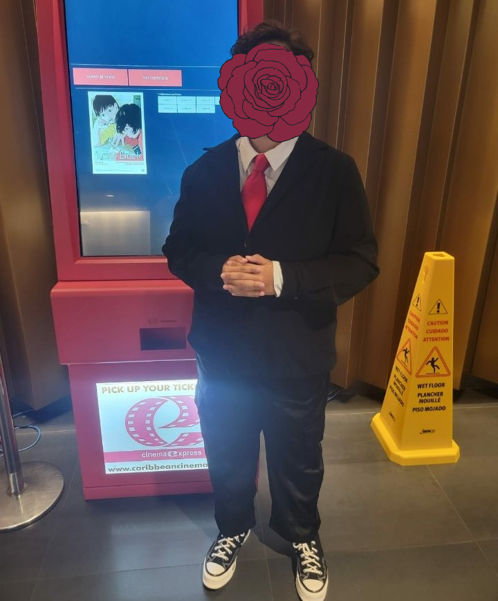 me in a black suit with a red tie. and converse of course